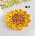 Hand-woven wool flower coaster with floral design, 15cm in diameter.