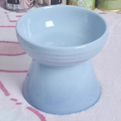 White ceramic pet bowl with a high foot base and wide, shallow eating area for dogs and cats