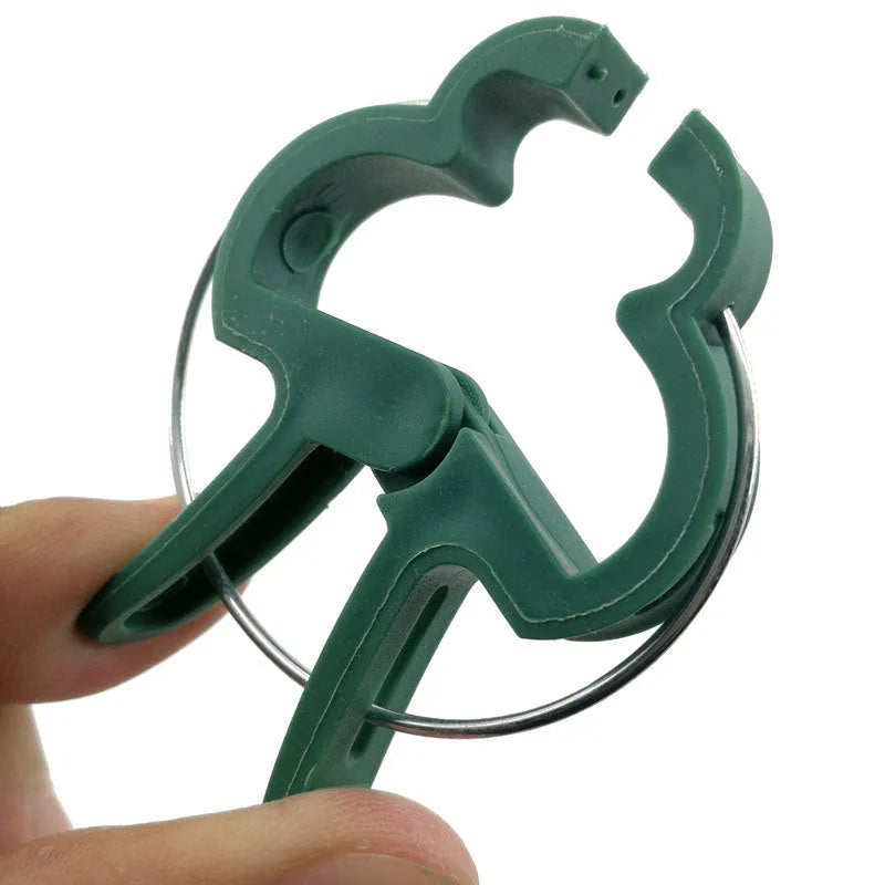 Green plastic and zinc plant fixing clips in large and small sizes for securing tomato vines and climbing plants.