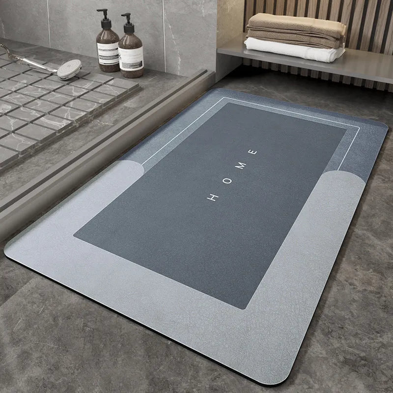 Machine-woven rectangular blue floor mat placed on a bathroom floor.