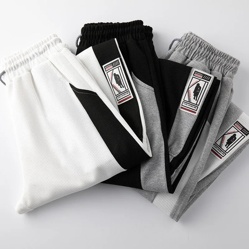Men's casual wide leg fleece lined trousers in black, front view, showing drawstring waist and straight leg silhouette