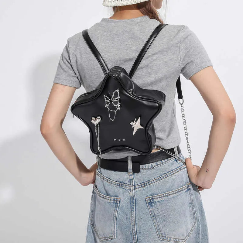 Soft PU leather women's mini backpack in black, shown being worn cross-body.