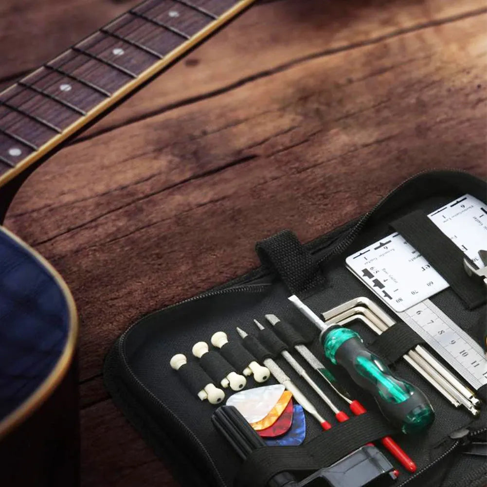 Black zippered case open to reveal 21 metal and plastic guitar repair tools including cutters, wrenches, and a winder.