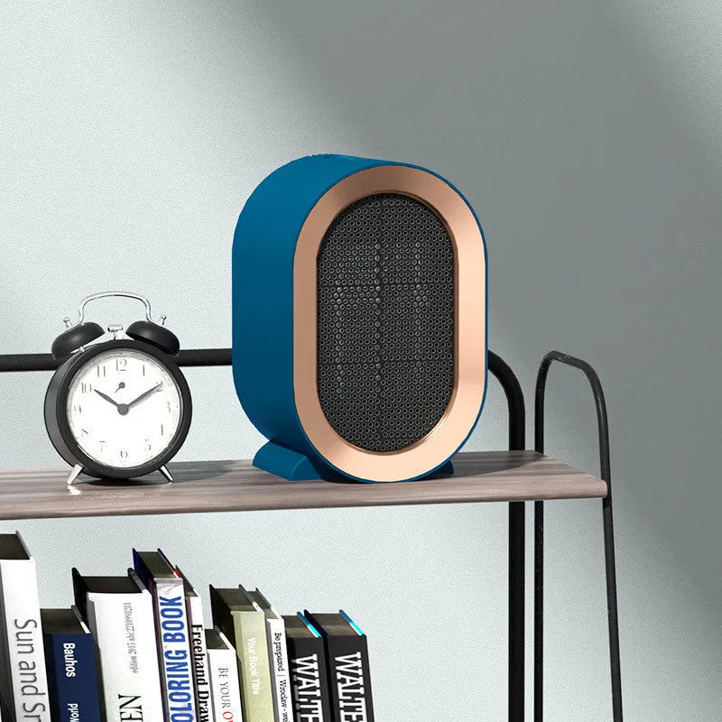 Compact black desktop electric fan heater with a front grille and mechanical control dials.