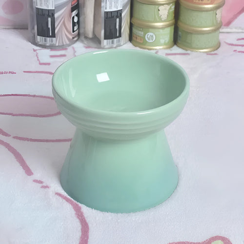 White ceramic pet bowl with a high foot base and wide, shallow eating area for dogs and cats