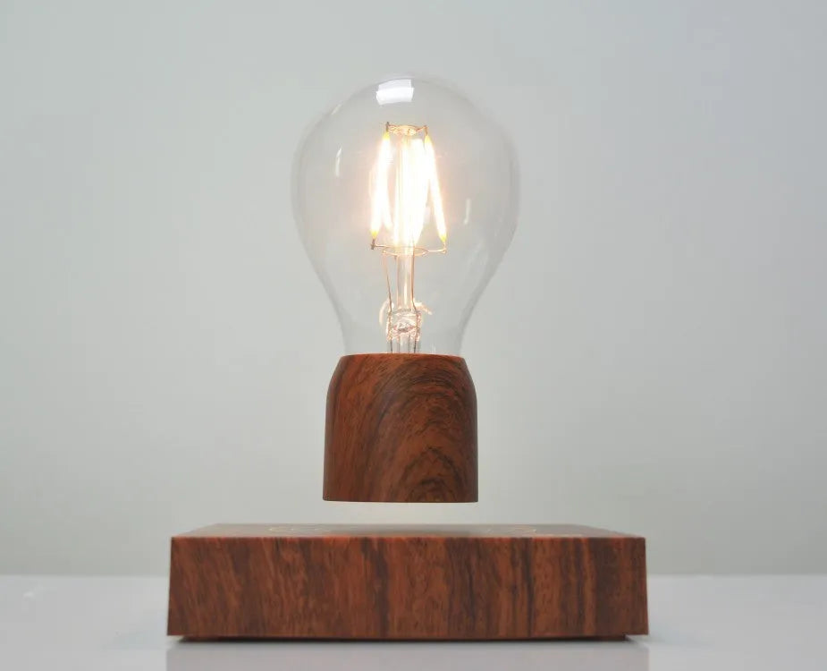 Magnetic levitation floating light bulb with imitation wood base.