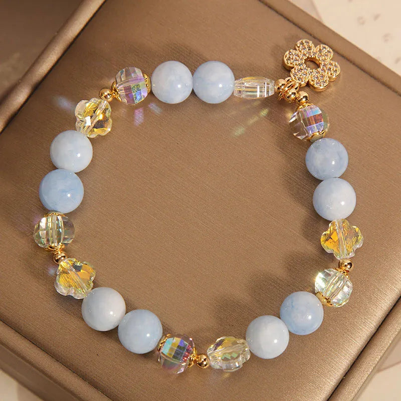 Women's aquamarine crystal bracelet with four-leaf clover charm and pearl decorative accents