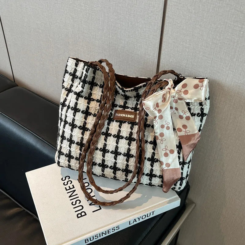 Black woven wool shoulder bag with horizontal square design and internal organisation compartments