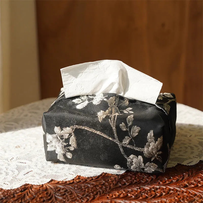 New Chinese style white brocade tissue box cover with embroidered plum blossoms on a table.