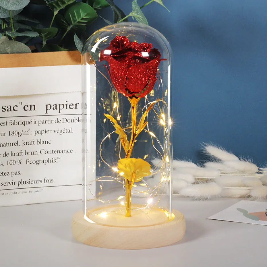 Handmade eternal red rose flower with warm white LED lights inside a clear glass dome display