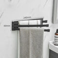 Nordic style black folding towel rack mounted on a bathroom wall with non-perforated installation.