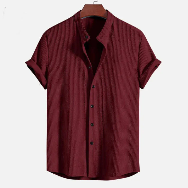Men's loose-fitting short sleeve shirt in light blue polyester fabric on a hanger.