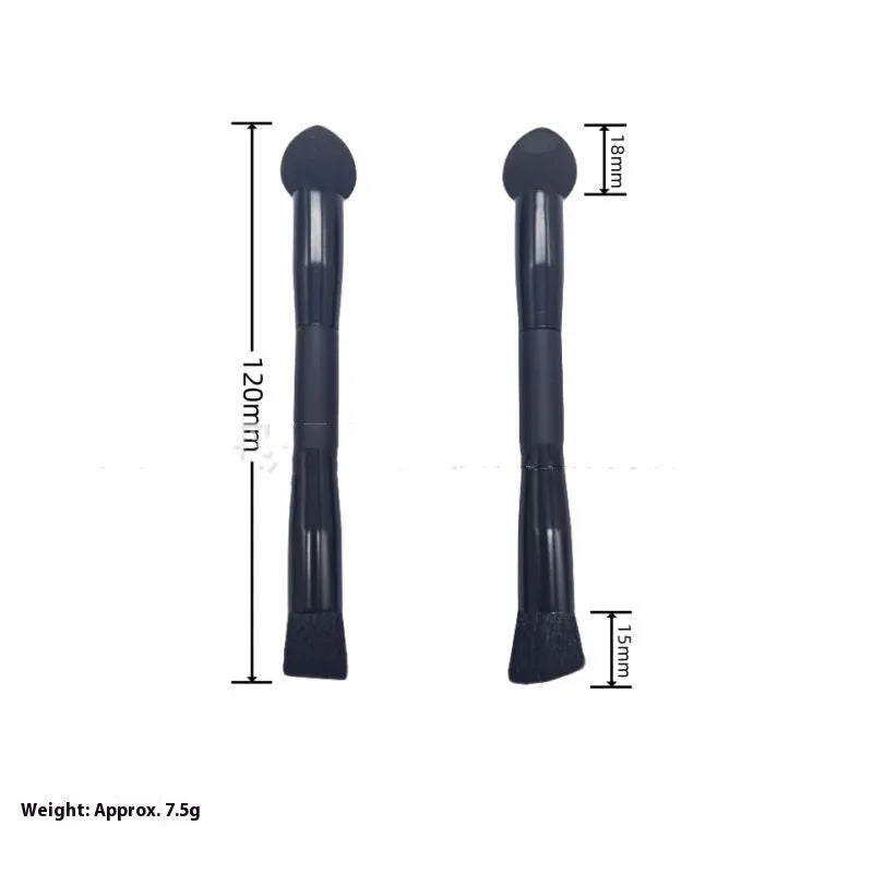 Black wooden handle concealer brush with a grey sponge tip applicator angled for under eye use.