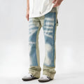 Yellow and blue retro patchwork jeans with a splash-ink damaged design on a mannequin.
