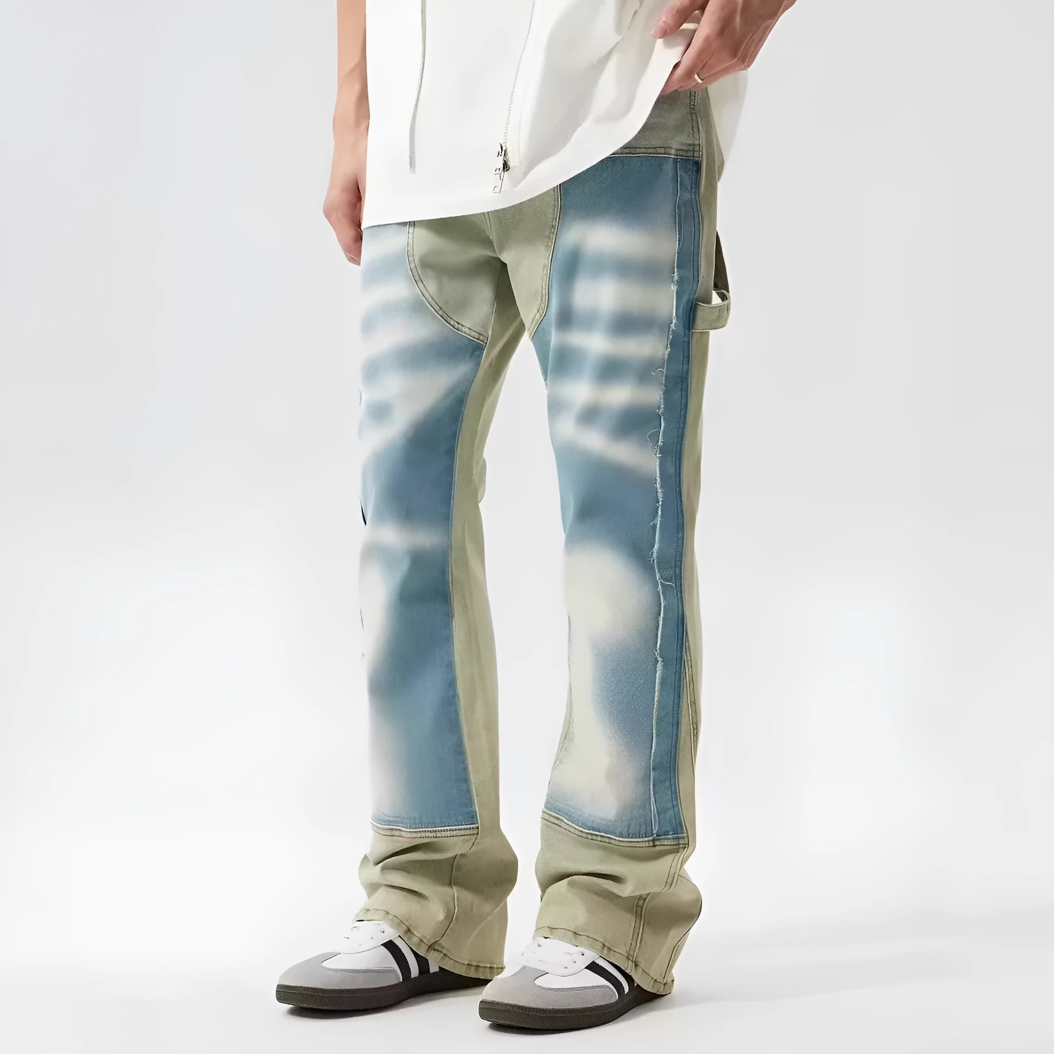 Yellow and blue retro patchwork jeans with a splash-ink damaged design on a mannequin.