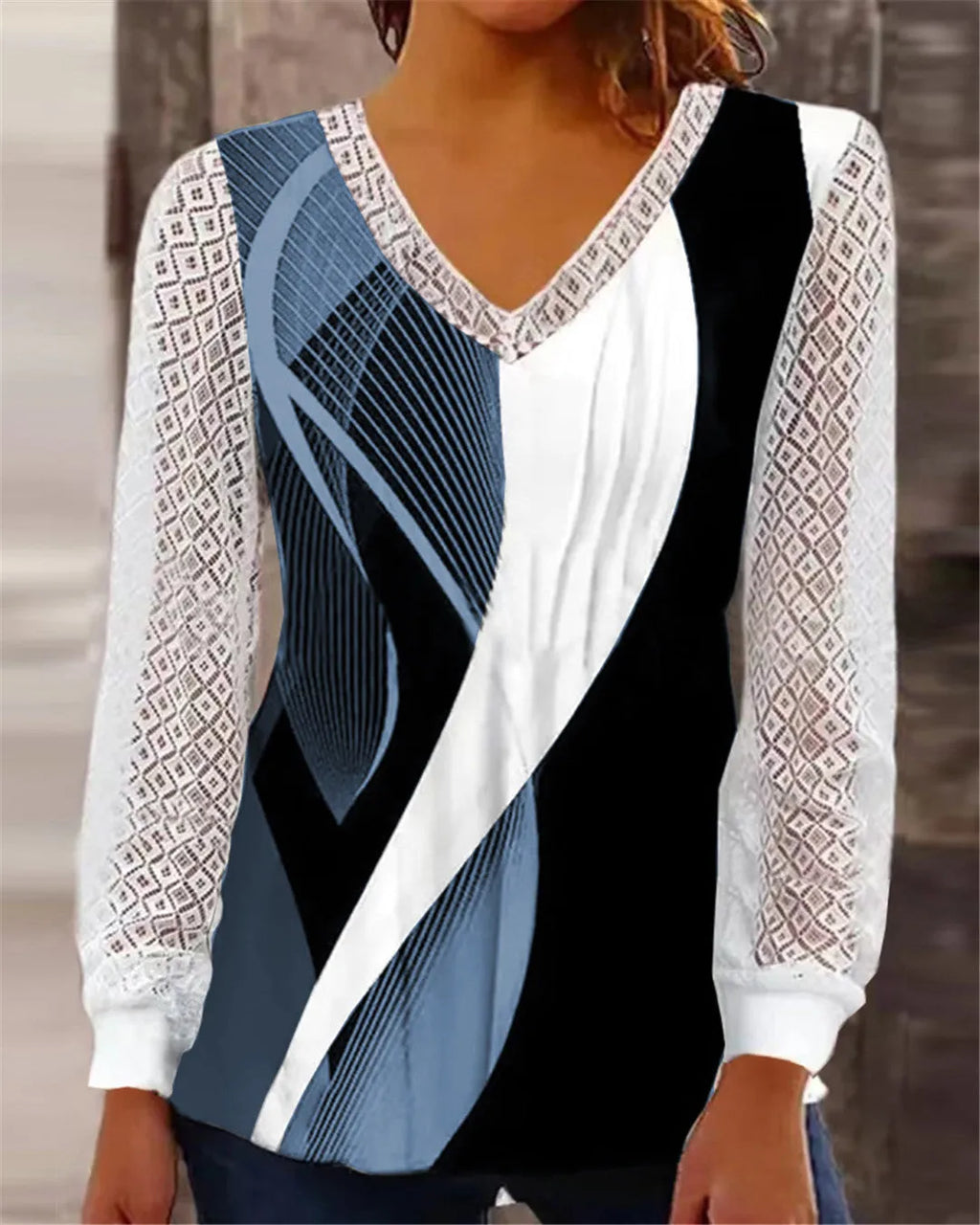 Women's loose purple V-neck lace top with long sleeves on a hanger.