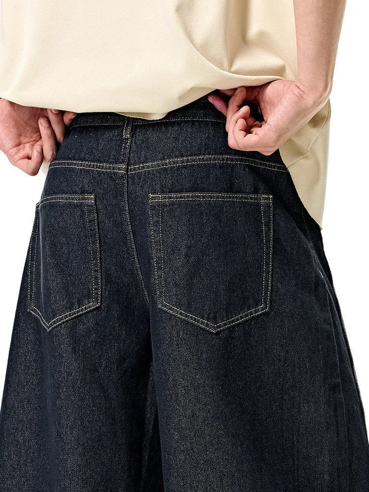 Men's wide leg denim trousers in original cow colour showing mid waist and relaxed fit.