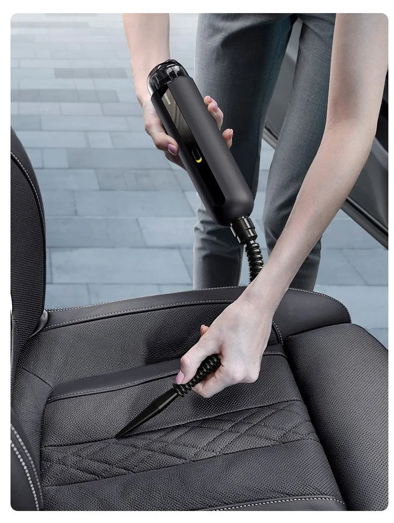 Starry sky black handheld cordless car vacuum cleaner with blowing hose accessory on a desktop.