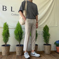 Men's straight-leg casual pants in black cotton fabric with drawstring waist closure