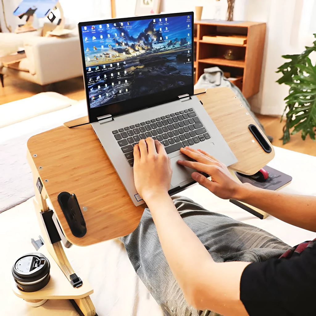 White maple wooden folding bed desk with laptop at an adjustable angle on a duvet.