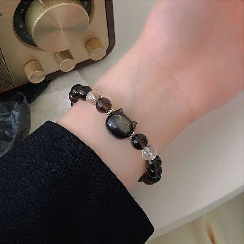 Women's silver bracelet with 8mm opal cat head charm on wrist