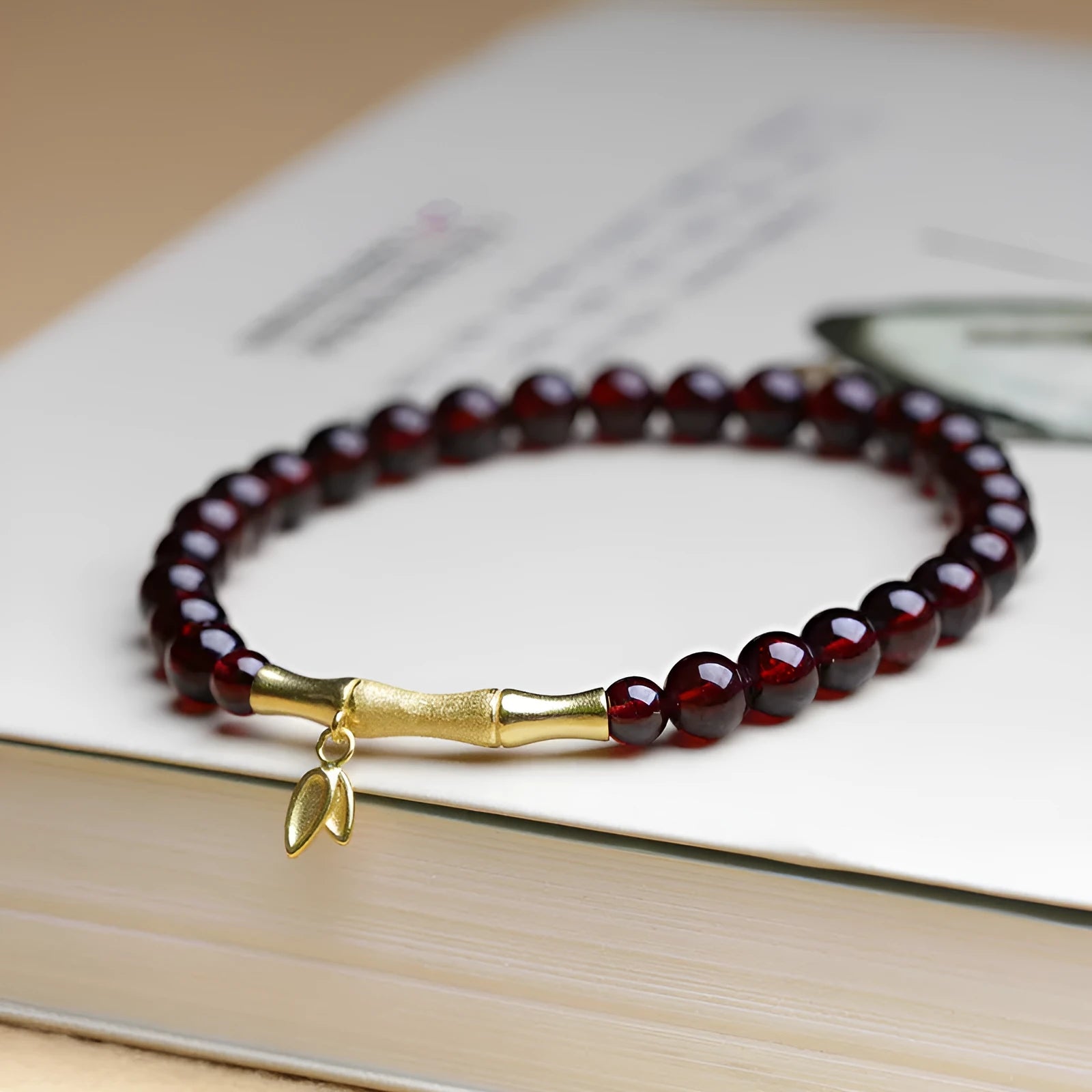 Handmade natural garnet bracelet with a 6mm silver or copper bamboo joint centrepiece.