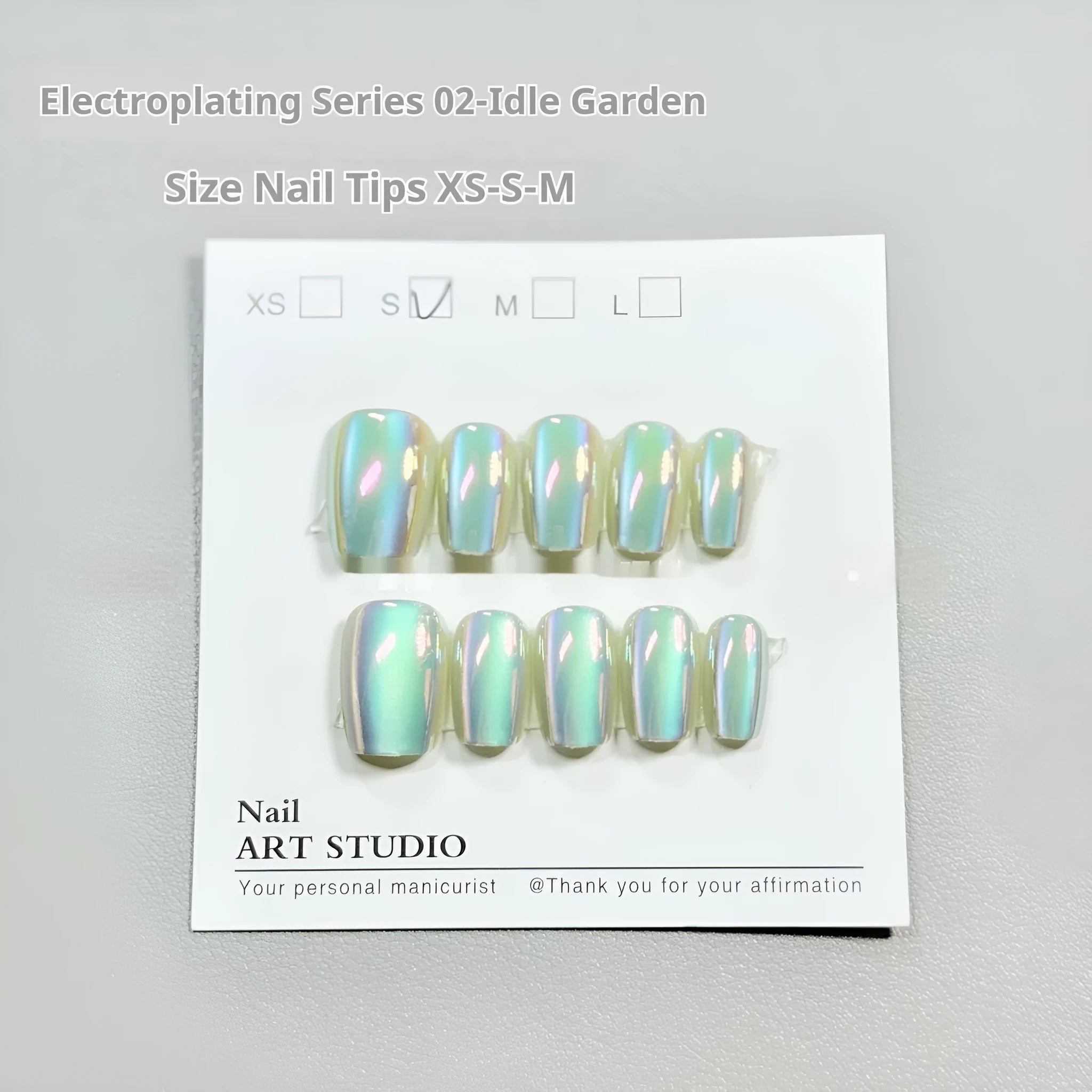 Set of electroplated Cat's Eye false nails in aurora armour style showing short ladder XS, S, and M sizes.
