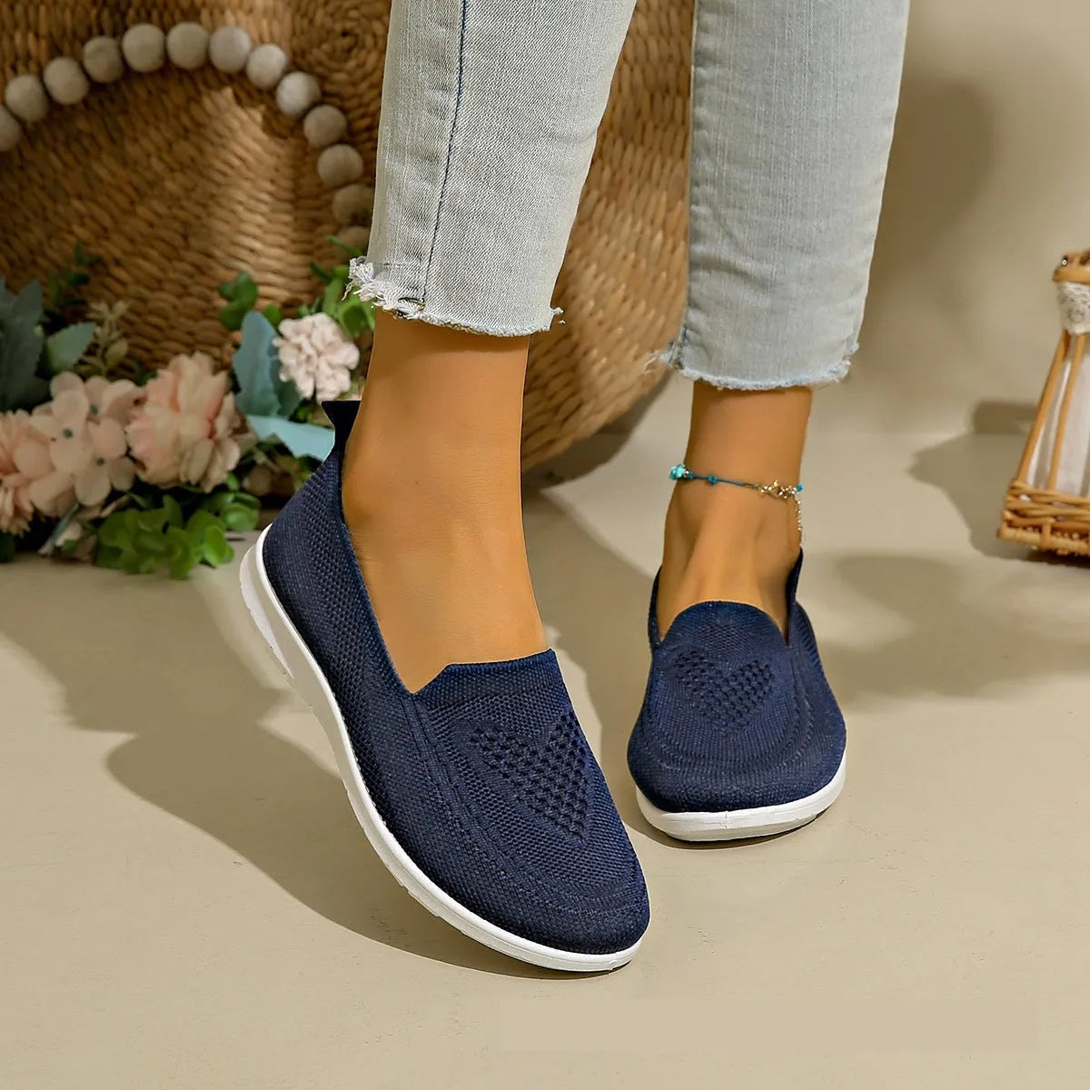 Women's beige canvas flat shoes with a heart pattern, mesh lining, and a flat rubber sole.