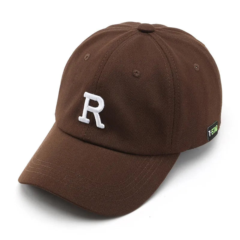 Adjustable cotton baseball cap with embroidered letter R in beige colour, dome style, unisex design