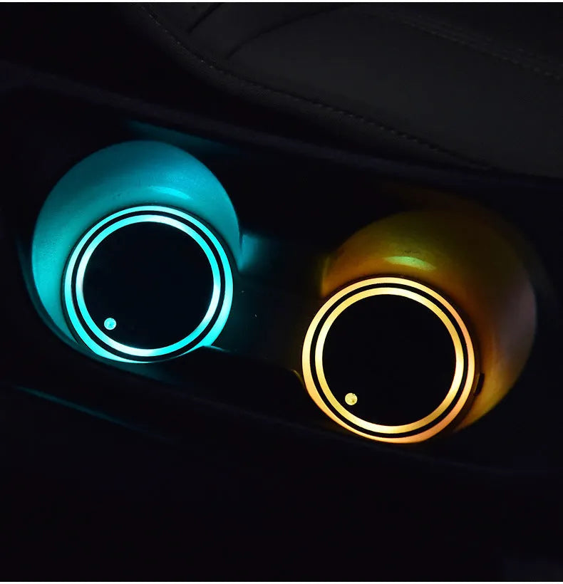 Colourful LED light-up coaster for car cup holder, showing multiple LED colours on a black acrylic base.