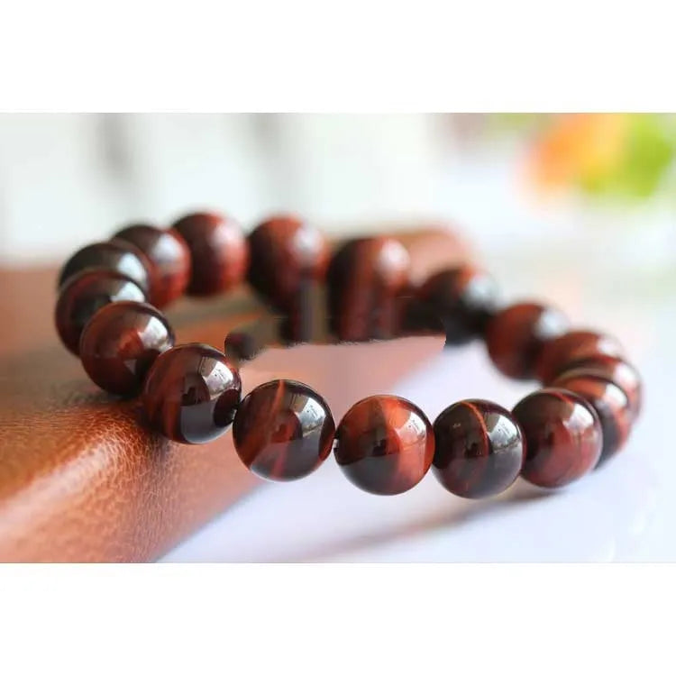 Tiger's eye stone bracelet with lightning cat's eye pattern in a round geometric ethnic style.