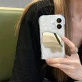 Solid colour iPhone case with water ripple texture and a small mirror, shown in beige colour.