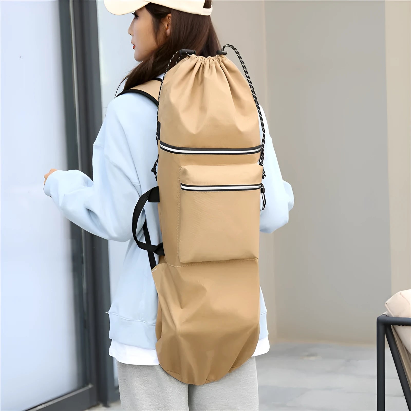 Black waterproof nylon bag for carrying a skateboard and fishing rod, shown with yoga mat.