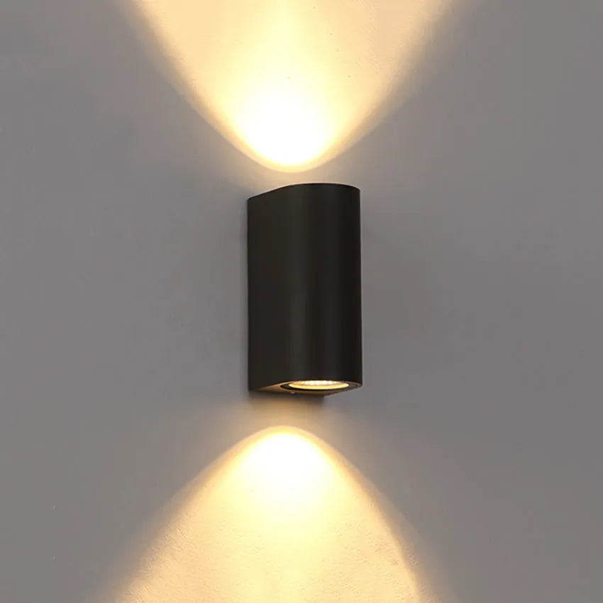 Modern black aluminium LED wall lamp with glass shade and silicone rubber trim.