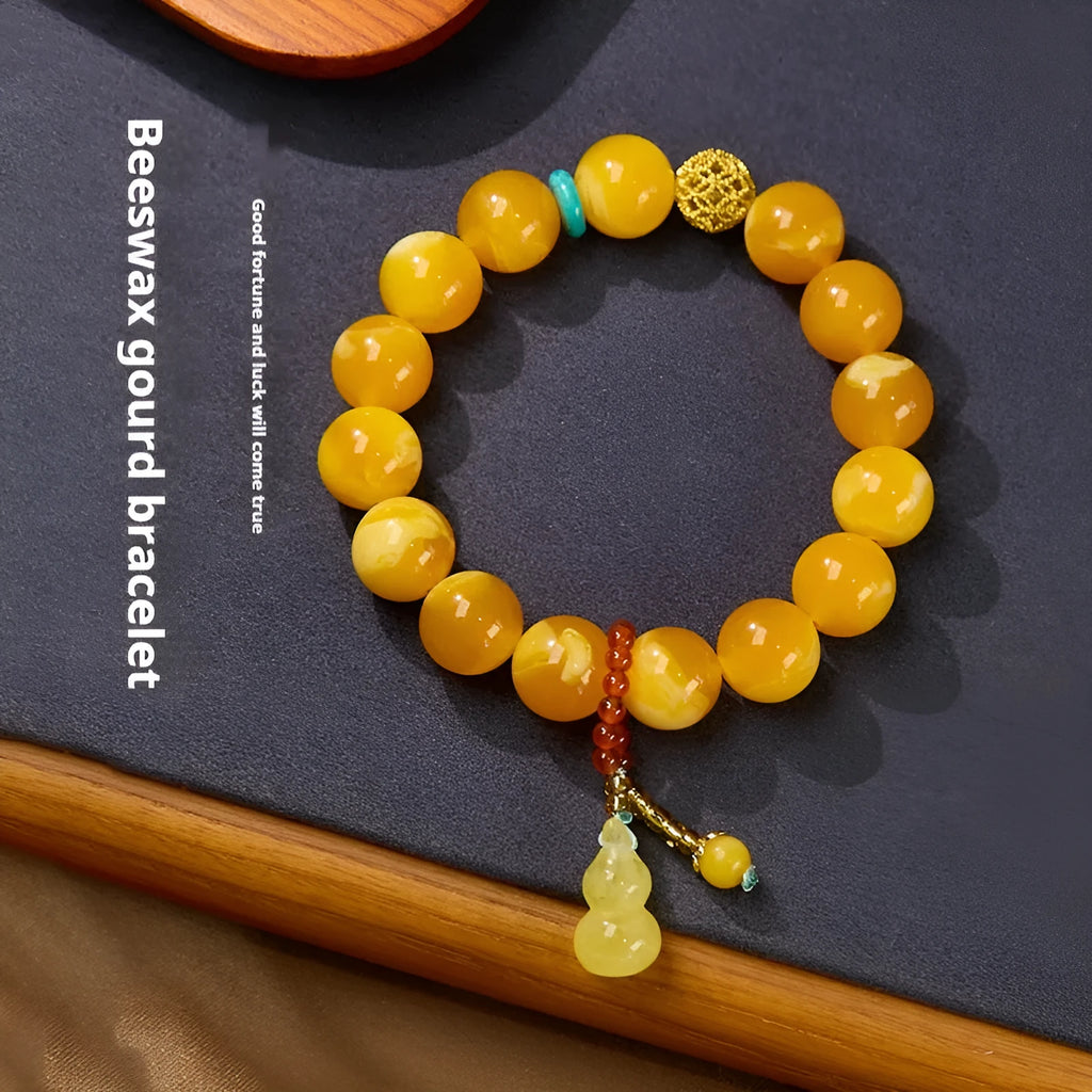 Natural beeswax Gourd Fu Lu bracelet in two sizes 12mm and 6mm on plain background