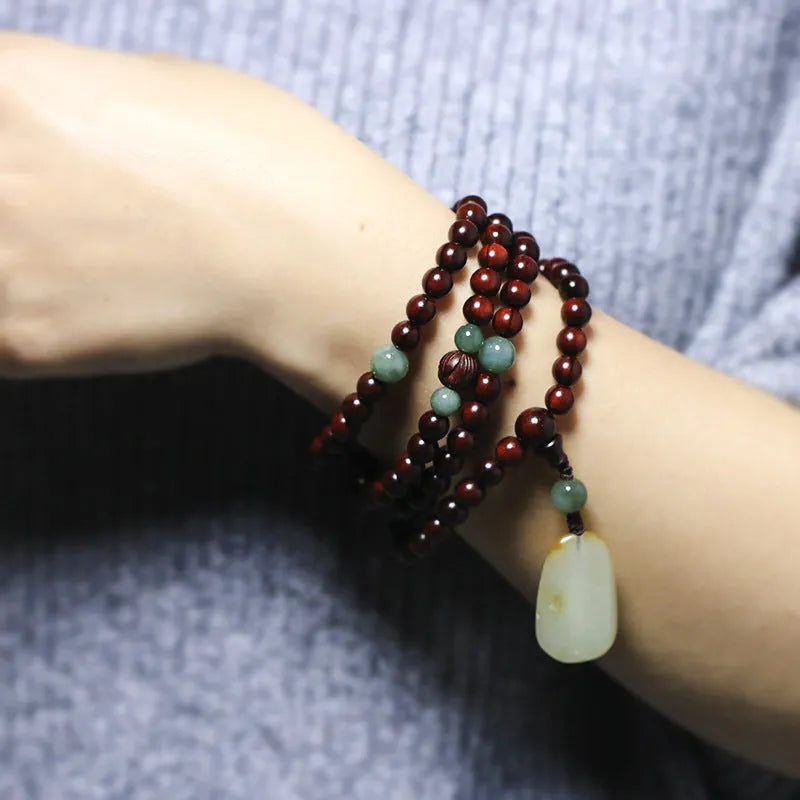 Rosewood bead bracelet with a carved Pterocarpus Santalinus and Hotian Jade stone pendant.