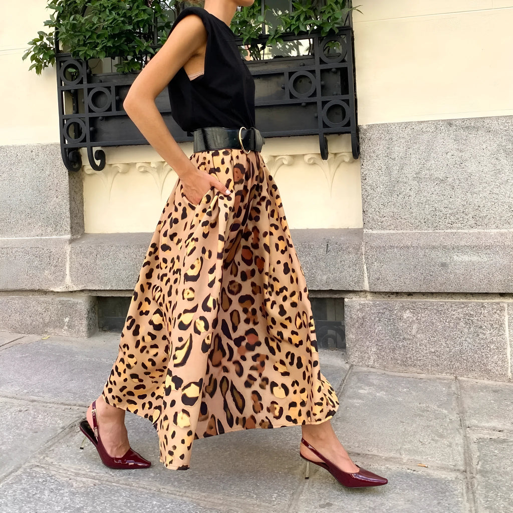 Brown leopard print women's A-line long skirt with a wide flowing hem on a model.