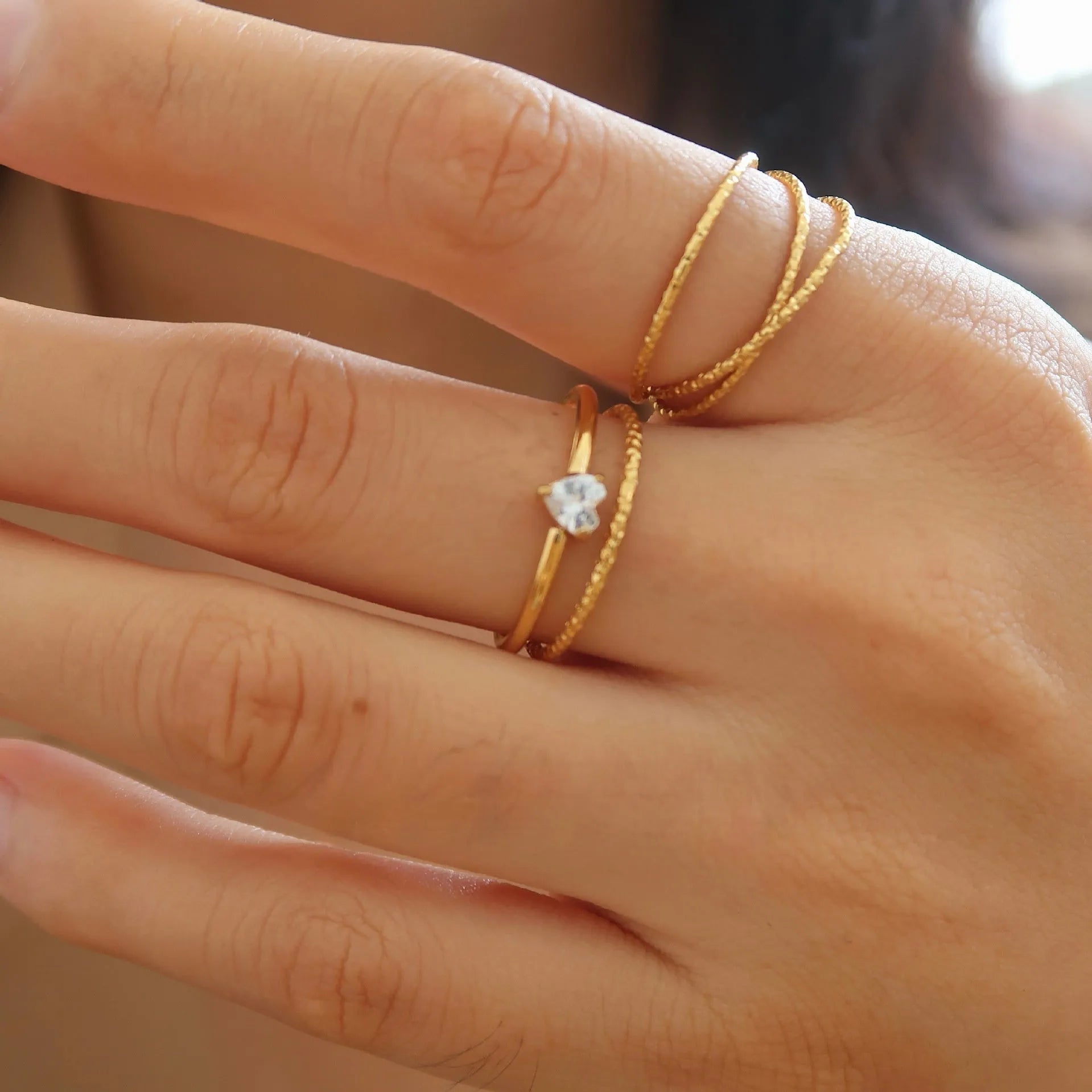Golden stainless steel simple bracelet with love heart and oval designs showing electroplated surface