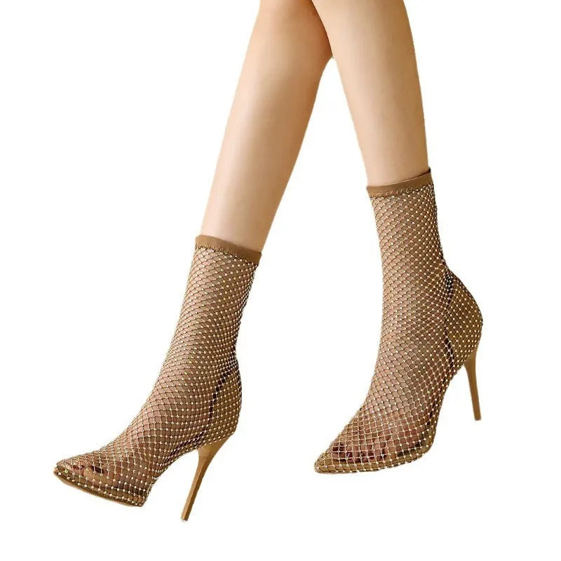Gold high heel sandals with a mesh upper and pointed stiletto design on a rubber sole.
