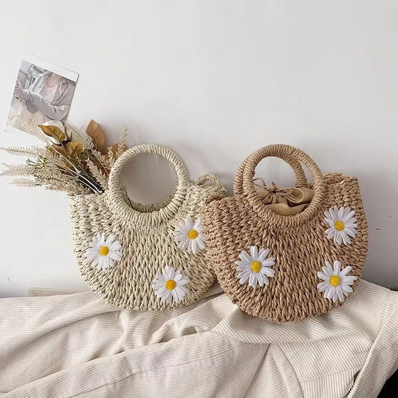 Light brown woven straw women's crossbody bag with a daisy pattern design.