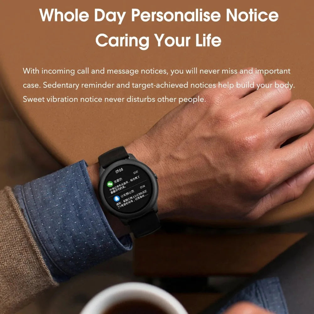 Black round smart watch with heart rate and sleep monitor on wrist, alloy case and silicone band