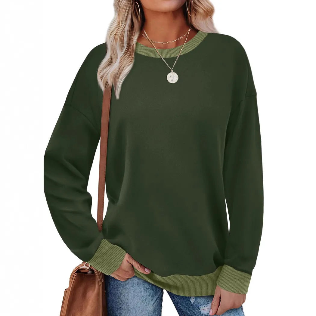 Woman wearing a loose-fitting striped long sleeve top with a round neckline in a grey colour.
