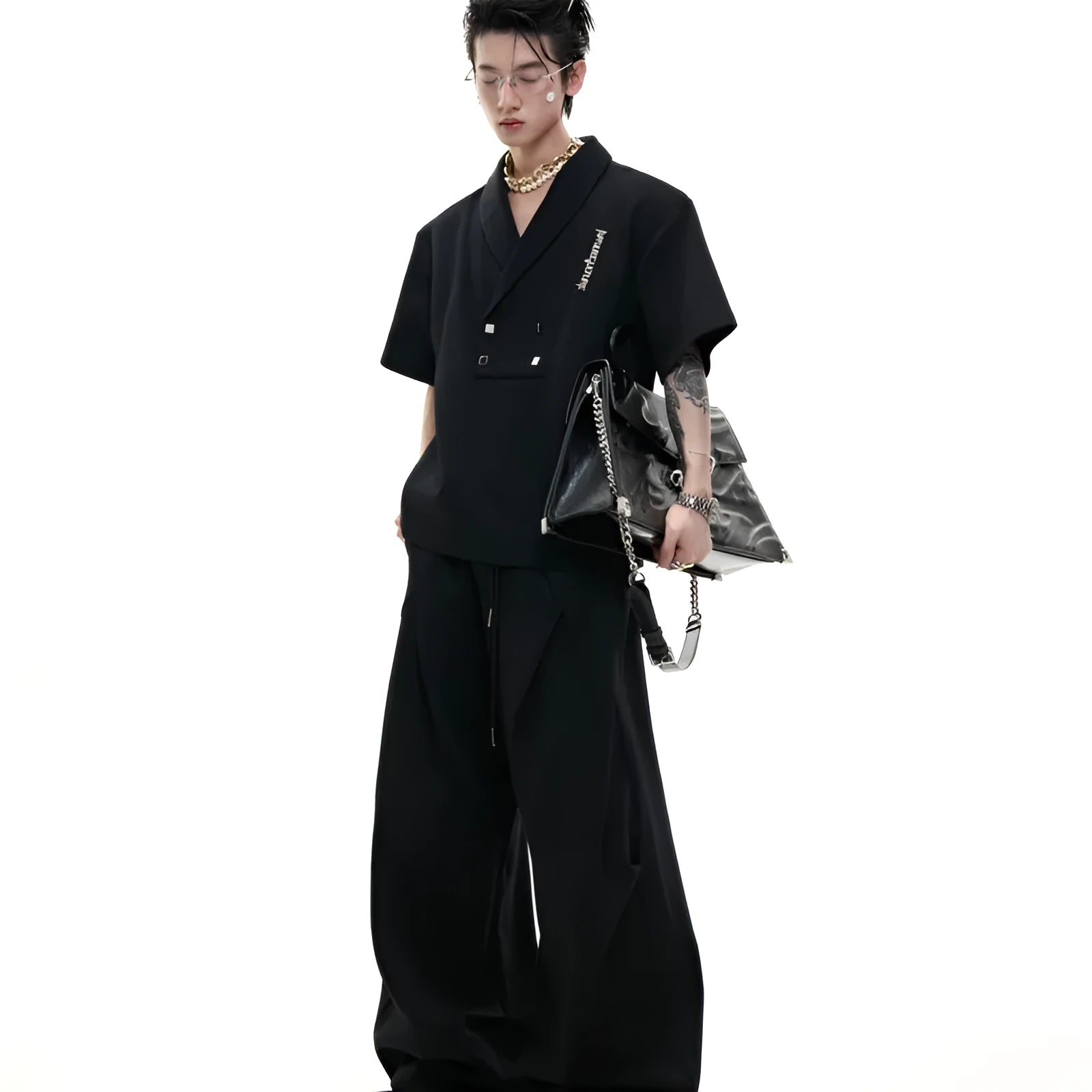 Men's dark grey V-neck sports suit with padded shoulders, metal details, and cotton shorts laid flat.