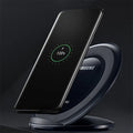 Black and white Qi wireless fast charging pad compatible with Samsung Galaxy Note Edge smartphone.