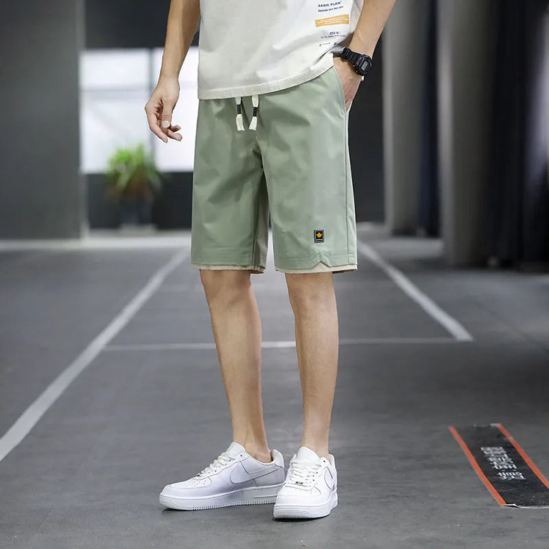 Men's loose-fit straight-leg beach shorts in polyester, shown in a khaki colour.