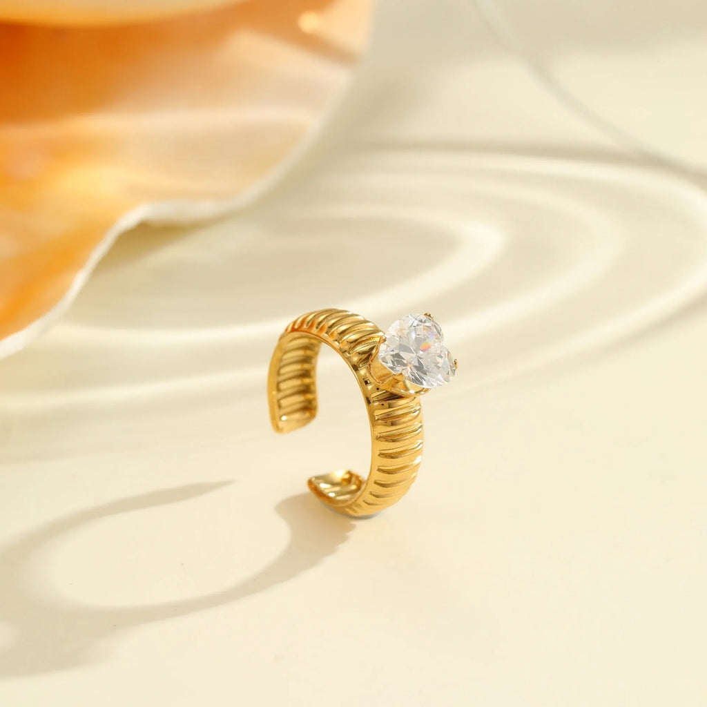 Gold electroplated stainless steel ring with zircon accents in open mouth geometry design
