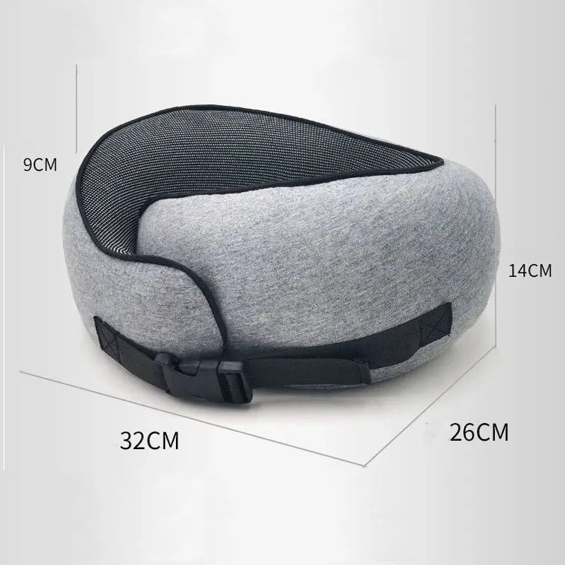 Navy blue U-shaped travel neck pillow rolled up next to its carry bag