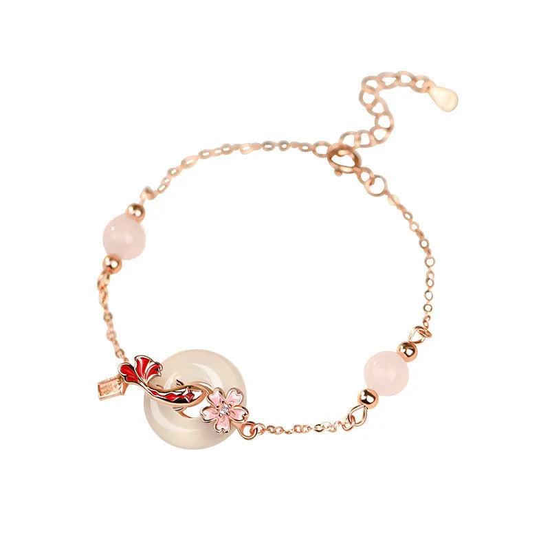 Close-up of a women's S925 sterling silver bracelet with a white chalcedony crystal flower and koi-themed design.