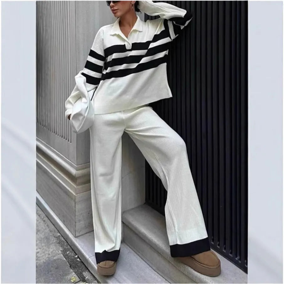 Women's black and white striped polo collar knitted top with matching trousers, a casual two-piece set.