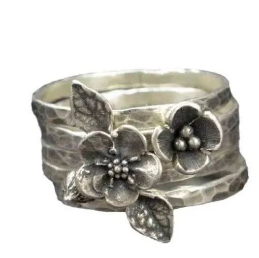 Silver alloy ring with carved honeycomb and bee flower shape on white background